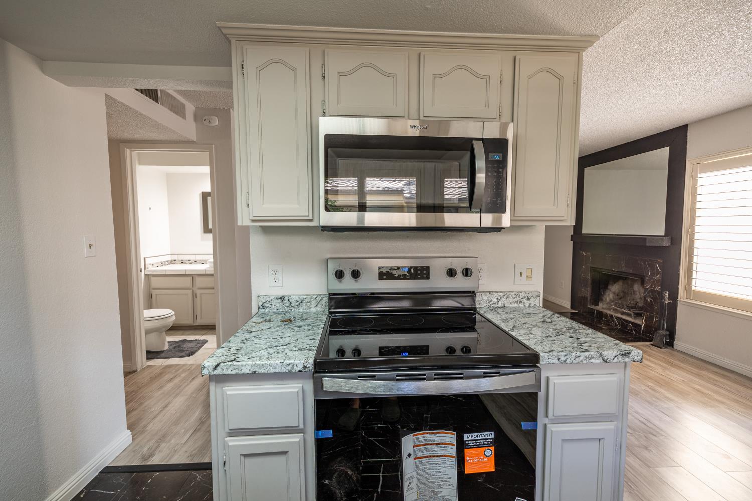 3700 Tully Road, Unit 5 Modesto, CA 95356 - Photo 10 of 38 a kitchen with a stove and a microwave