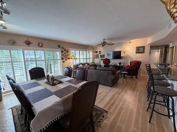 a living room with furniture a dining table and a fireplace