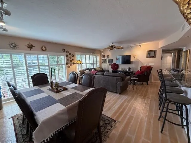 a living room with furniture a dining table and a fireplace