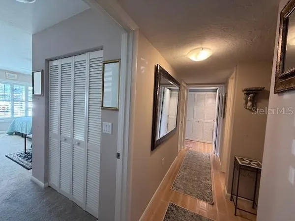 a view of hallway with a couch and a window