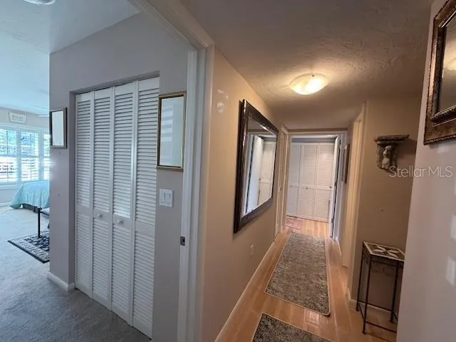 a view of hallway with a couch and a window