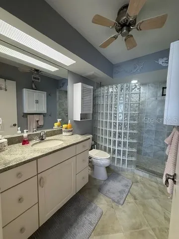 a bathroom with a toilet sink and shower