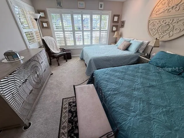 a bedroom with a large bed and a window