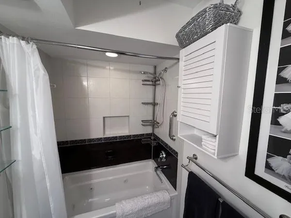 a bathroom with a sink a mirror and a shower