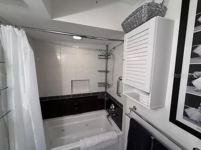 a bathroom with a sink a mirror and a shower