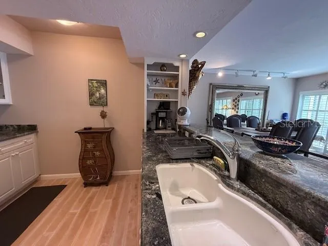 a room with furniture a flat screen tv and a sink