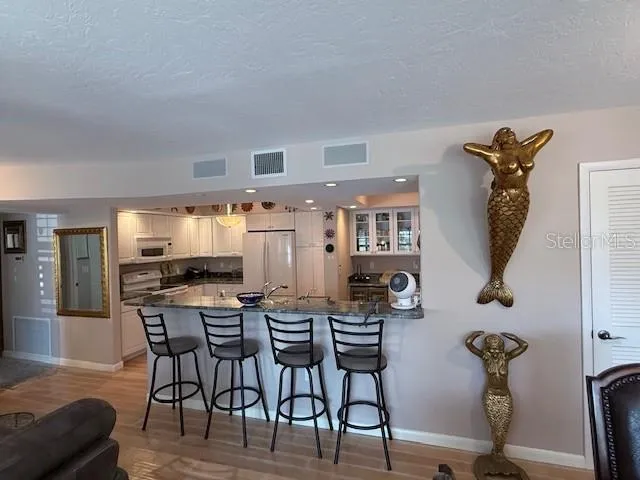 a view of a dining room with furniture and a chandelier
