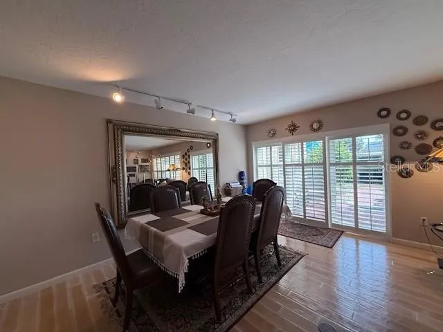 a view of a dining room with furniture window and wooden floor