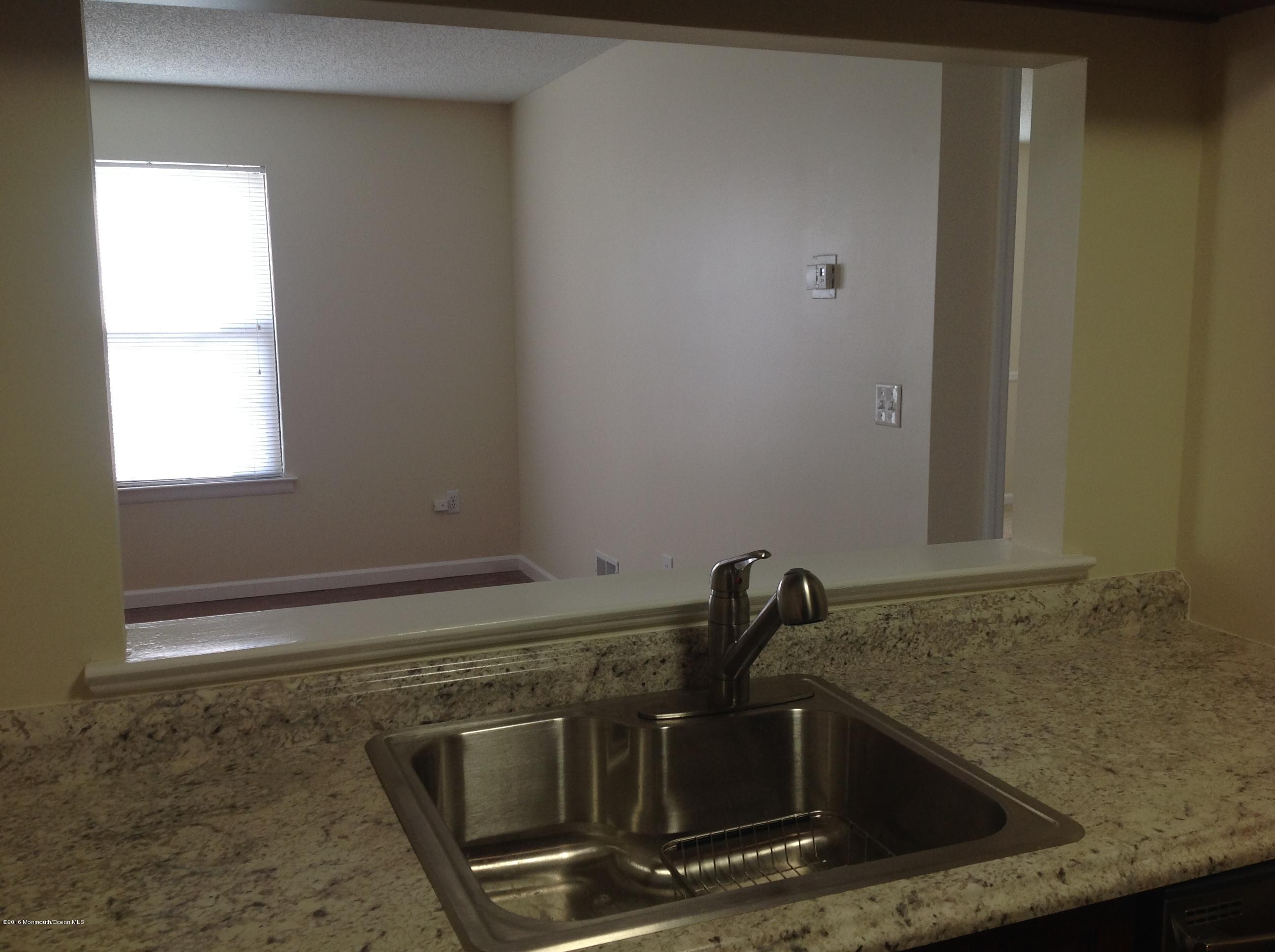 71 Azalea Circle Jackson, NJ 08527 - Photo 3 of 18 a close view of a sink a stove and granite counter top