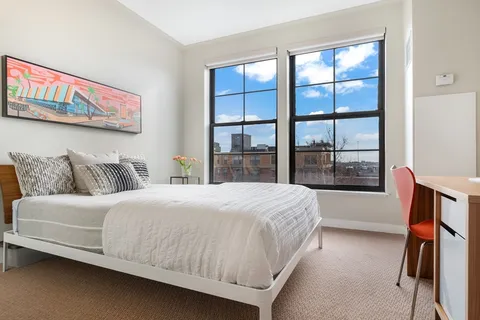 a bedroom with a large bed and a window