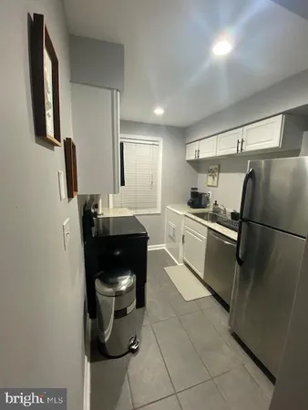 a stove top oven sitting inside of a kitchen