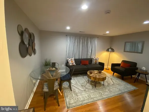 a living room with furniture and a rug