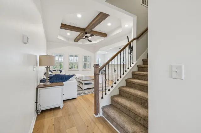 a view of entryway livingroom and hall with wooden floor