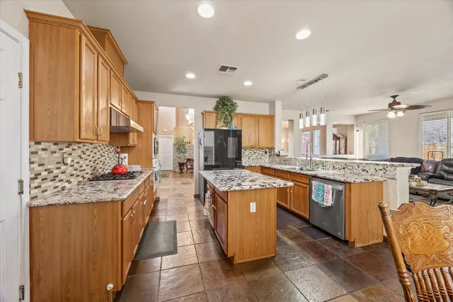 a bedroom with a bed and a flat tv screen on dresser