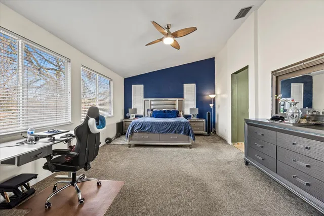 a living room with patio furniture and a floor to ceiling window