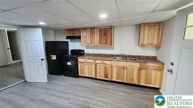 a kitchen with stainless steel appliances granite countertop a refrigerator and a sink
