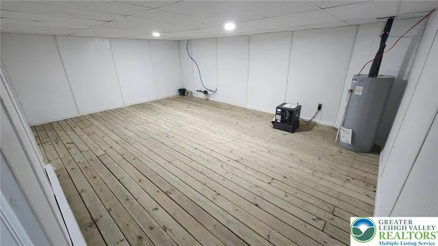 a view of an empty room with wooden floor and closet