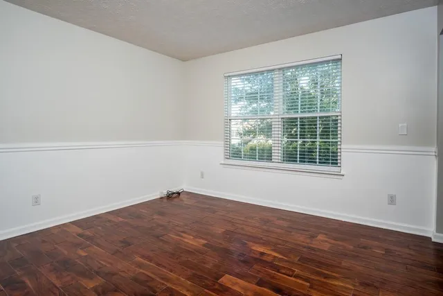 a view of a room with wooden floor and windows