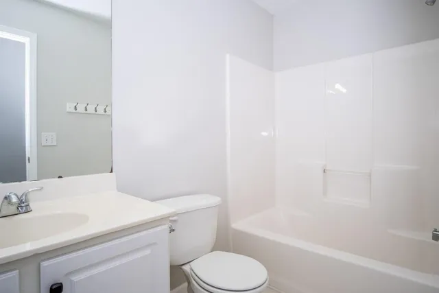 a bathroom with a sink toilet vanity and bathtub
