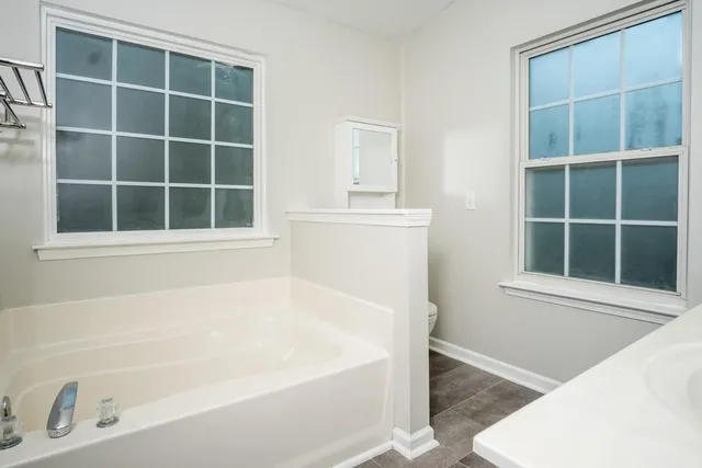 a white bath tub sitting next to a window