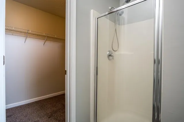 a bathroom with a glass shower door