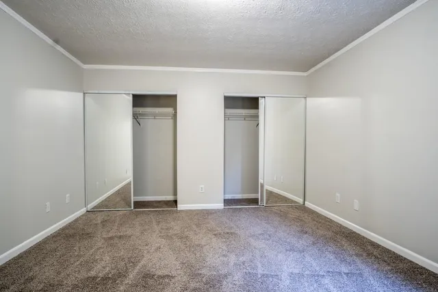 an empty room with closet area