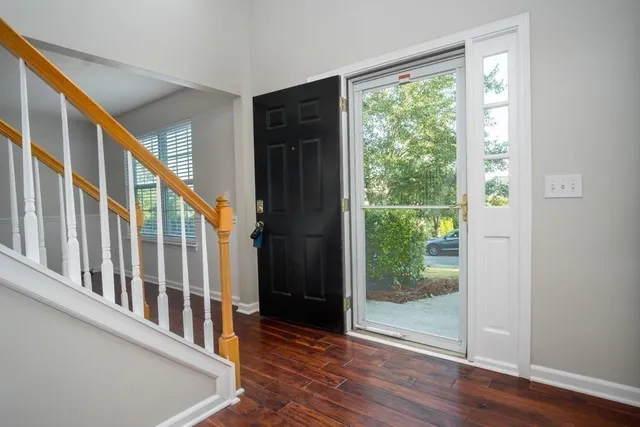a view of an entryway with wooden floor and windows