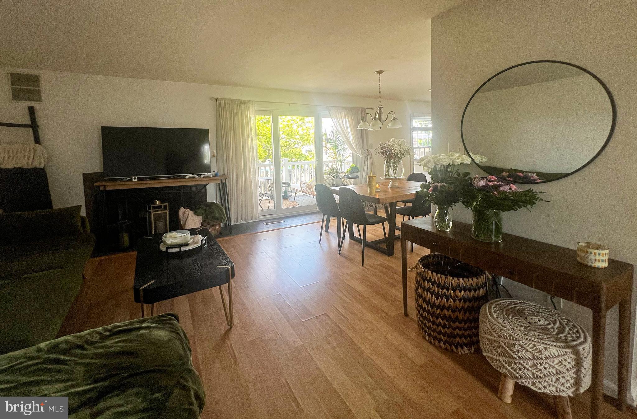 155 39th Street South Brigantine, NJ 08203 - Photo 3 of 17 a living room with furniture a flat screen tv and a large window