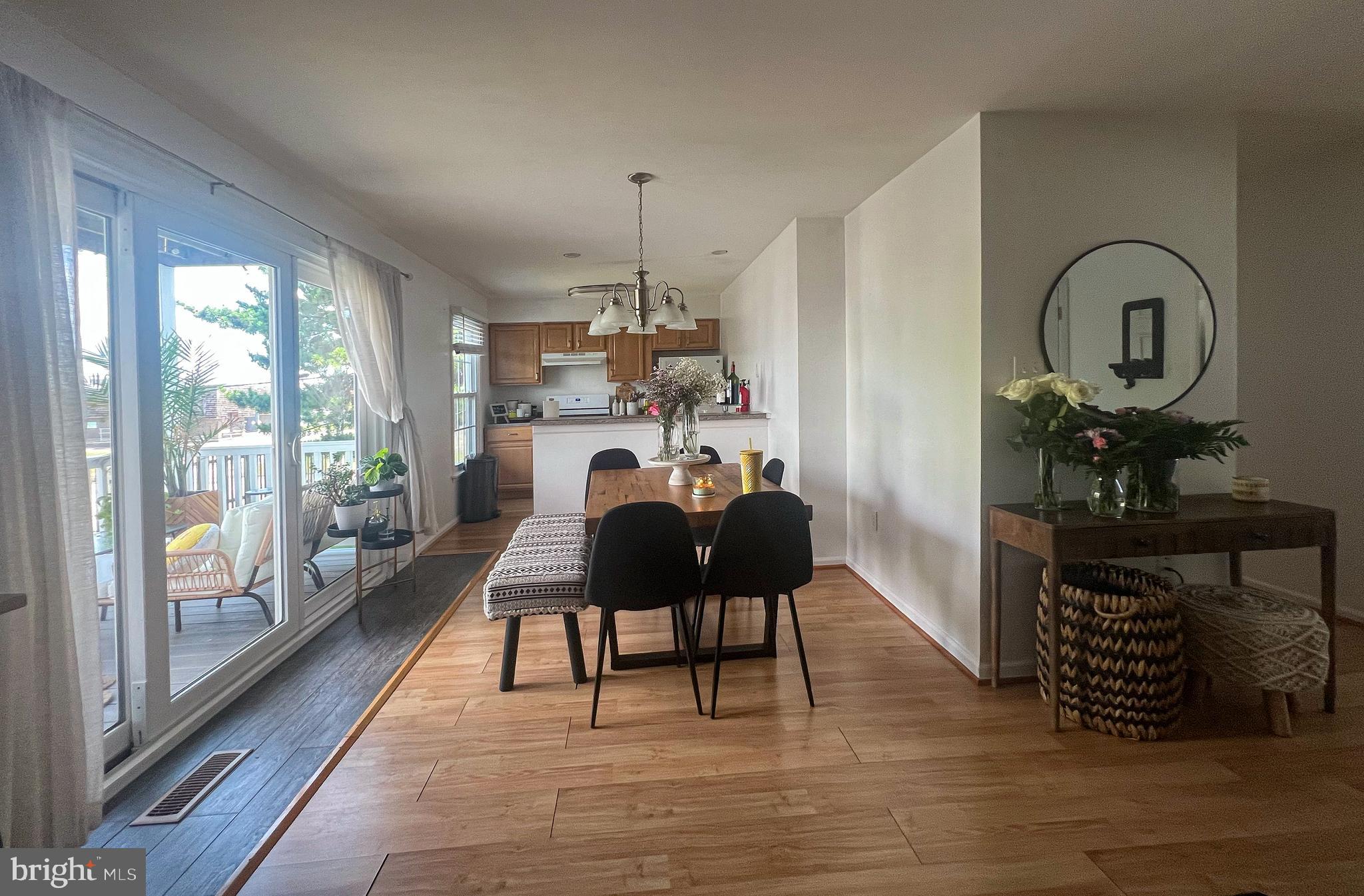 155 39th Street South Brigantine, NJ 08203 - Photo 4 of 17 a living room with furniture a rug a fireplace and a floor to ceiling window