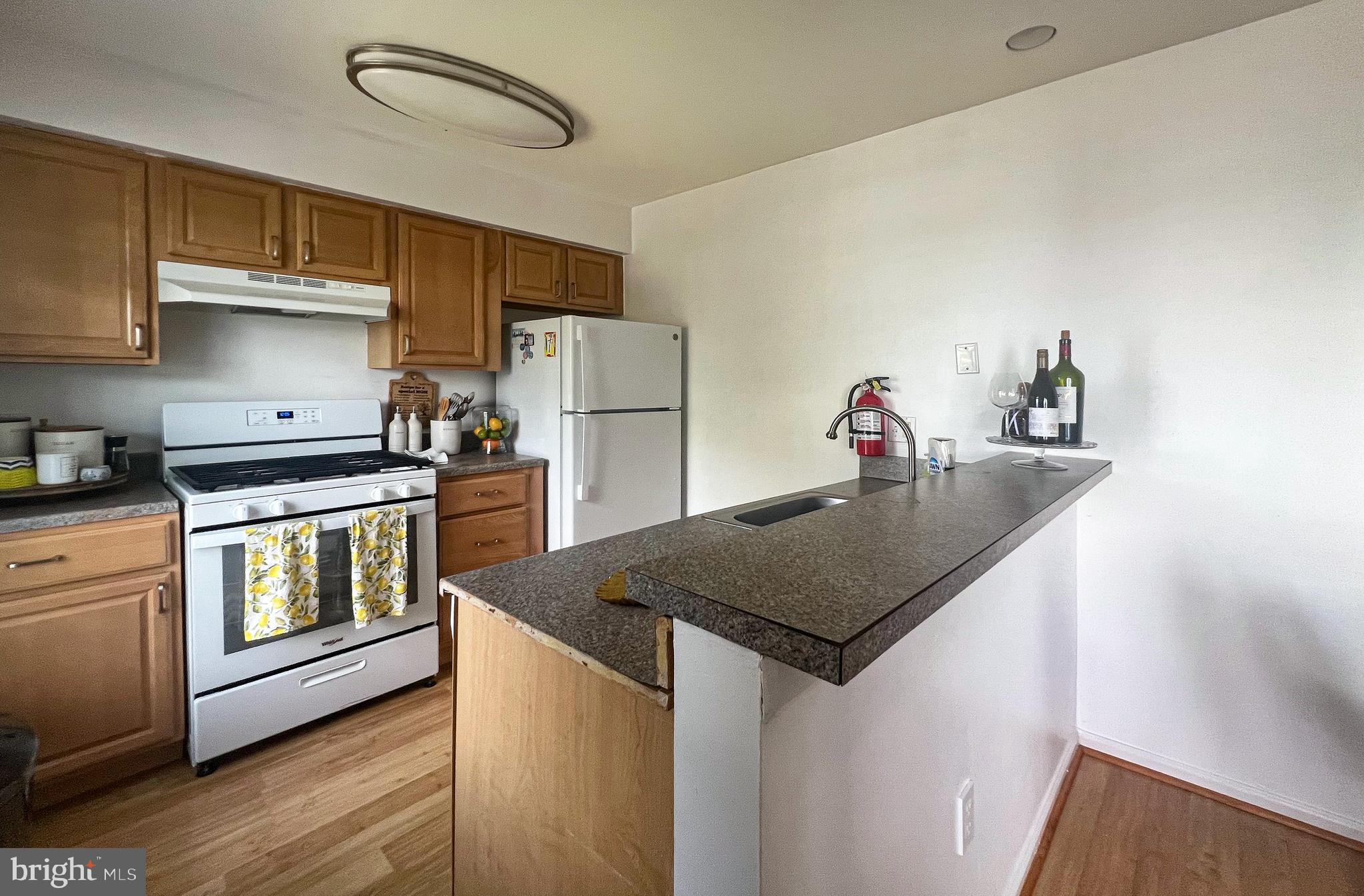 155 39th Street South Brigantine, NJ 08203 - Photo 5 of 17 a kitchen with stainless steel appliances granite countertop a sink dishwasher a refrigerator and a stove