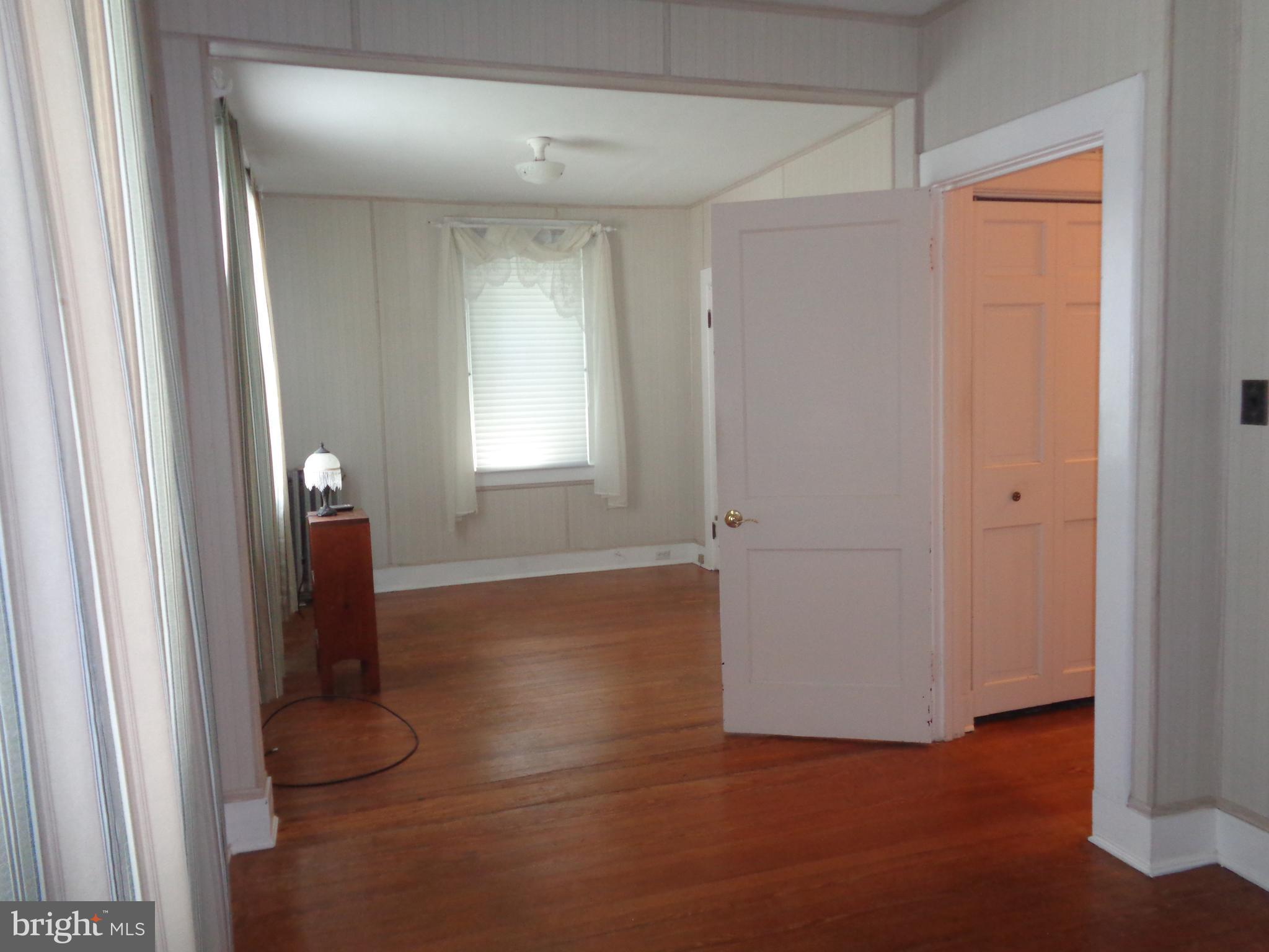 47 Broadship Road Baltimore, MD 21222 - Photo 11 of 27 a view of an empty room with wooden floor and a window