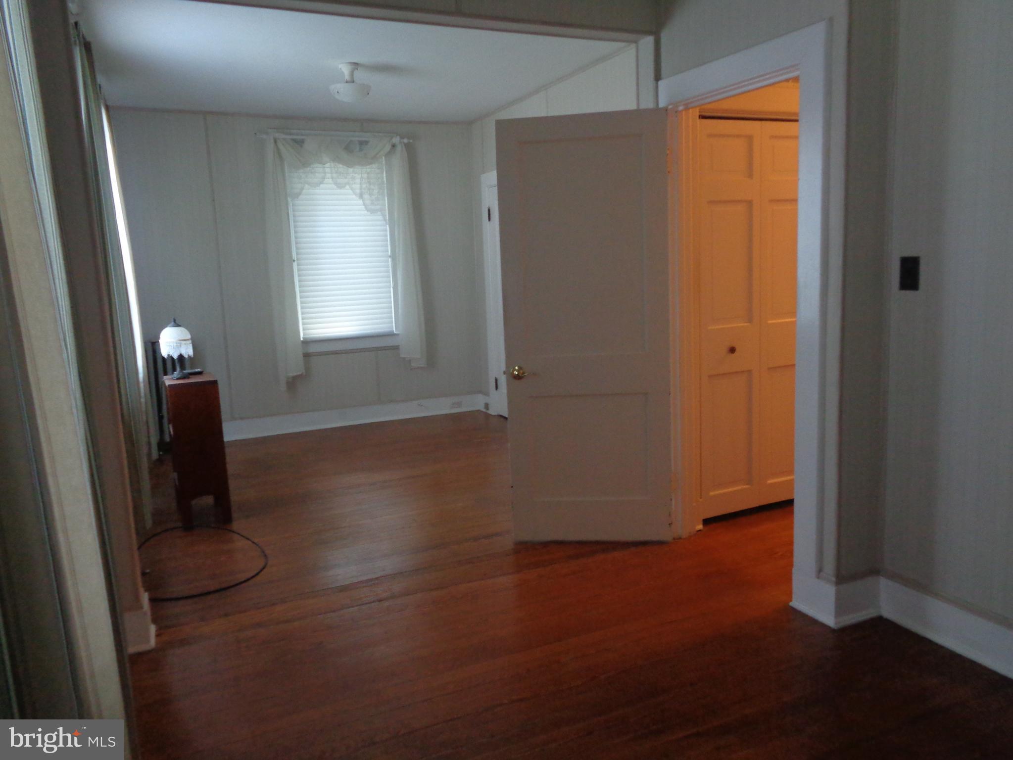 47 Broadship Road Baltimore, MD 21222 - Photo 19 of 27 an empty room with wooden floor and windows