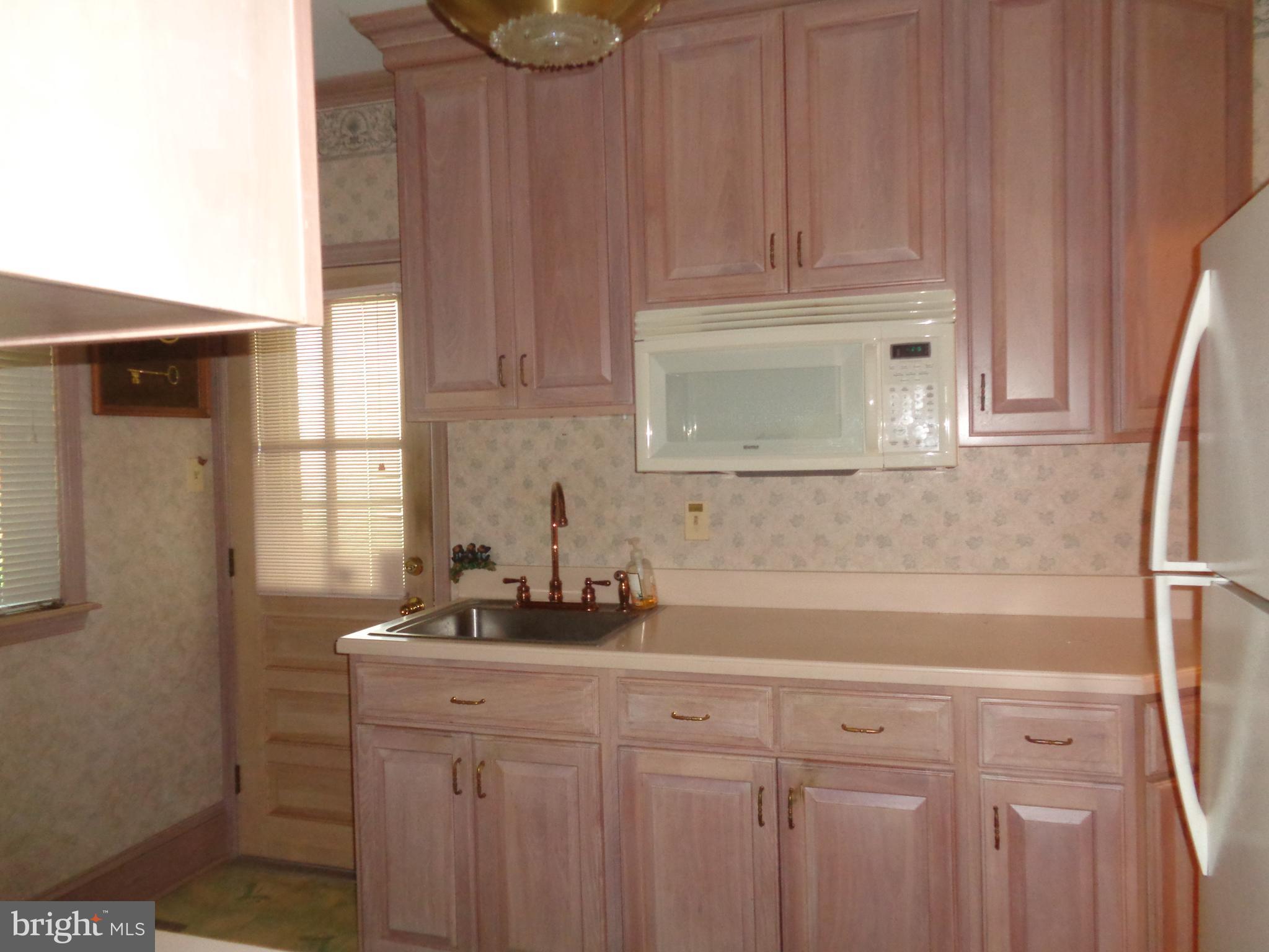 47 Broadship Road Baltimore, MD 21222 - Photo 5 of 27 a kitchen with a sink and cabinets
