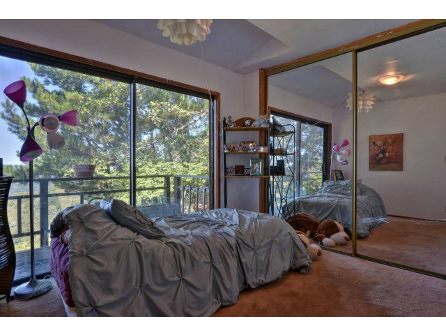 18554 Favre Ridge Road Los Gatos, CA 95033 - Photo 15 of 21 a bed room with a bed and a large window
