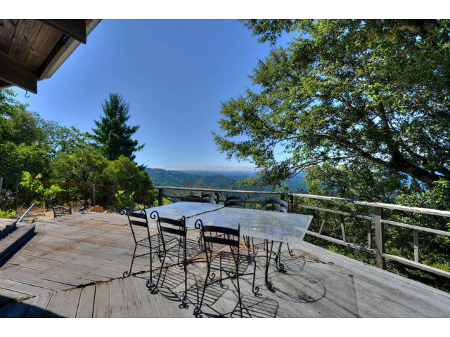 18554 Favre Ridge Road Los Gatos, CA 95033 - Photo 18 of 21 a view of a patio with table and chairs with wooden floor