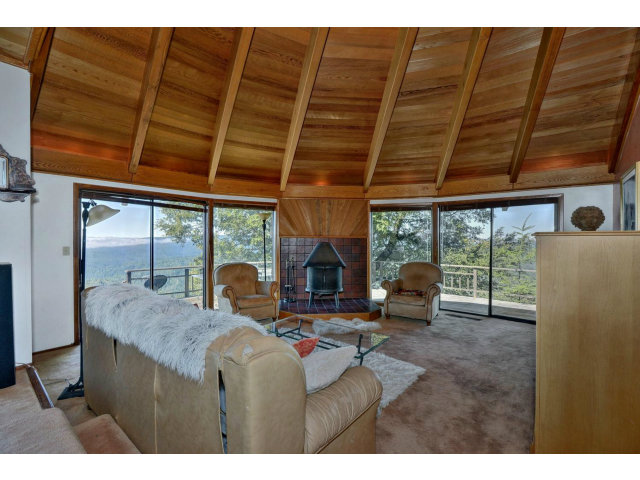 18554 Favre Ridge Road Los Gatos, CA 95033 - Photo 4 of 21 a living room with furniture a fireplace and a table