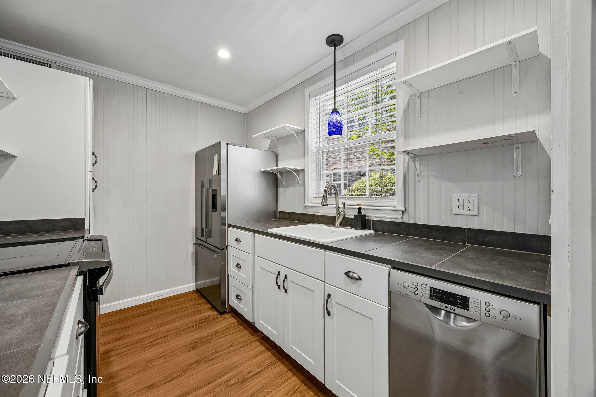 4358 Timuquana Road, Unit 134 Jacksonville, FL 32210 - Photo 8 of 31 a kitchen with granite countertop a sink appliances cabinets and counter space