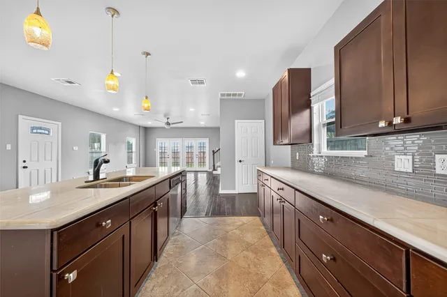 a kitchen with granite countertop a sink and cabinets
