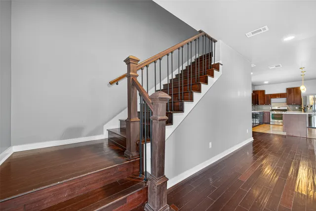 a view of entryway and hall with wooden floor