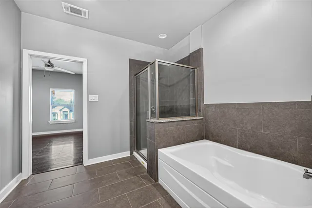 a bathroom with a bathtub and a shower
