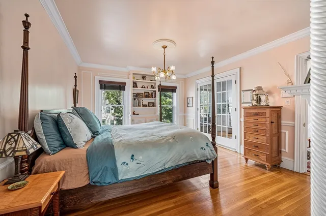 a bedroom with bed and wooden floor