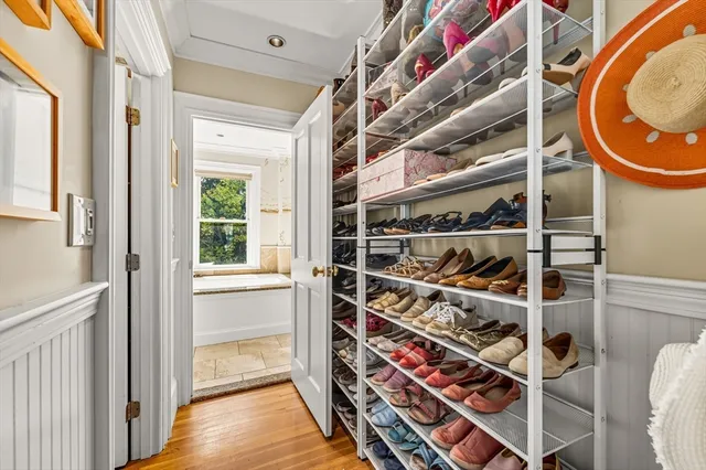 a view of walk in closet with clothes and shoes