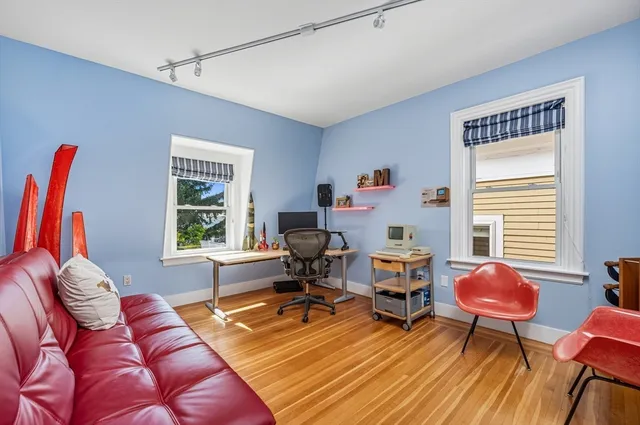 a living room with furniture a rug and a window