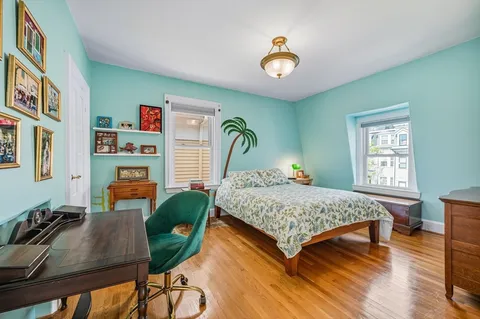 a bedroom with a bed window and a table