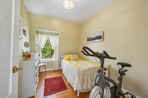 a bedroom with bed and a window