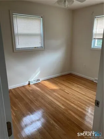 a view of a room with wooden floor and window
