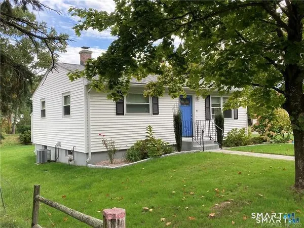 a view of a house with a backyard
