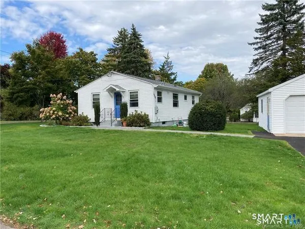 a front view of house with yard and green space