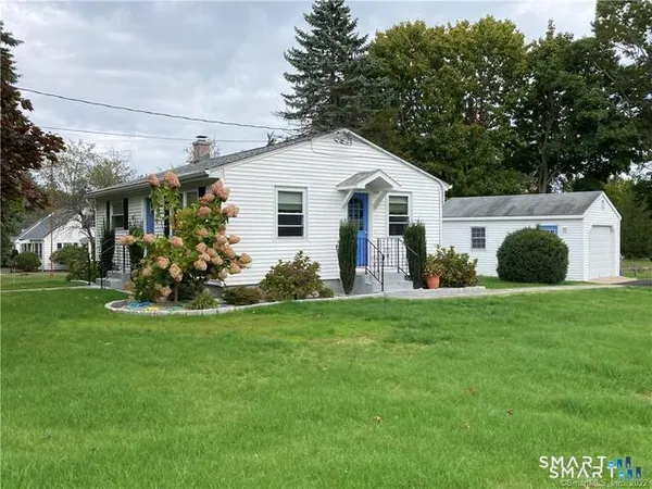 a view of a house with a backyard