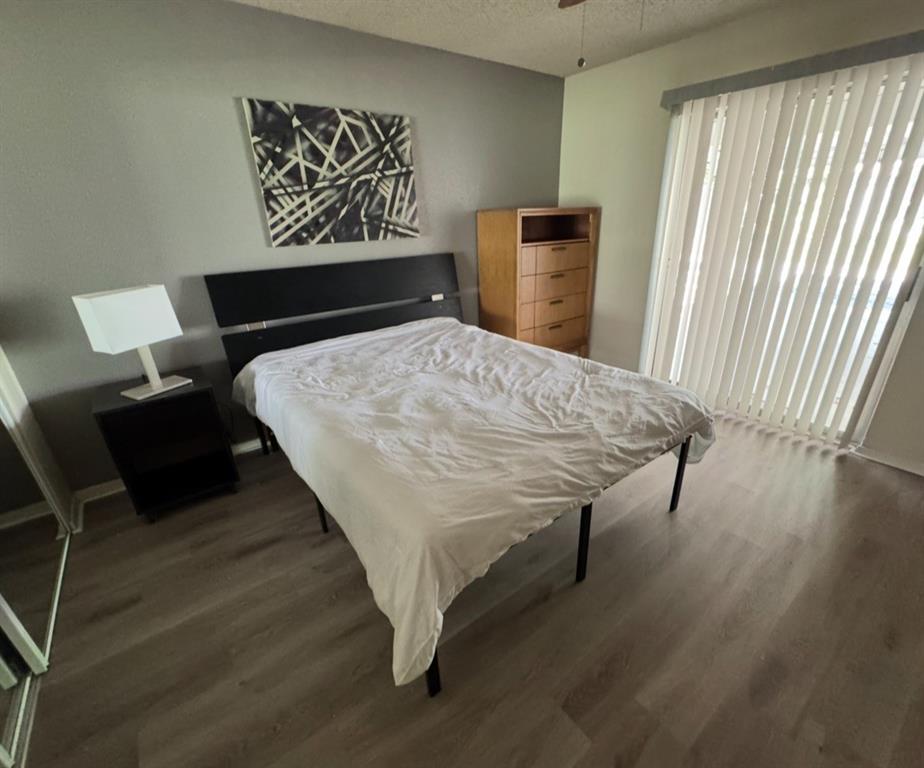 2708 McCart Avenue, Unit 2710 Fort Worth, TX 76110 - Photo 7 of 10 a bed sitting in a bedroom next to a window